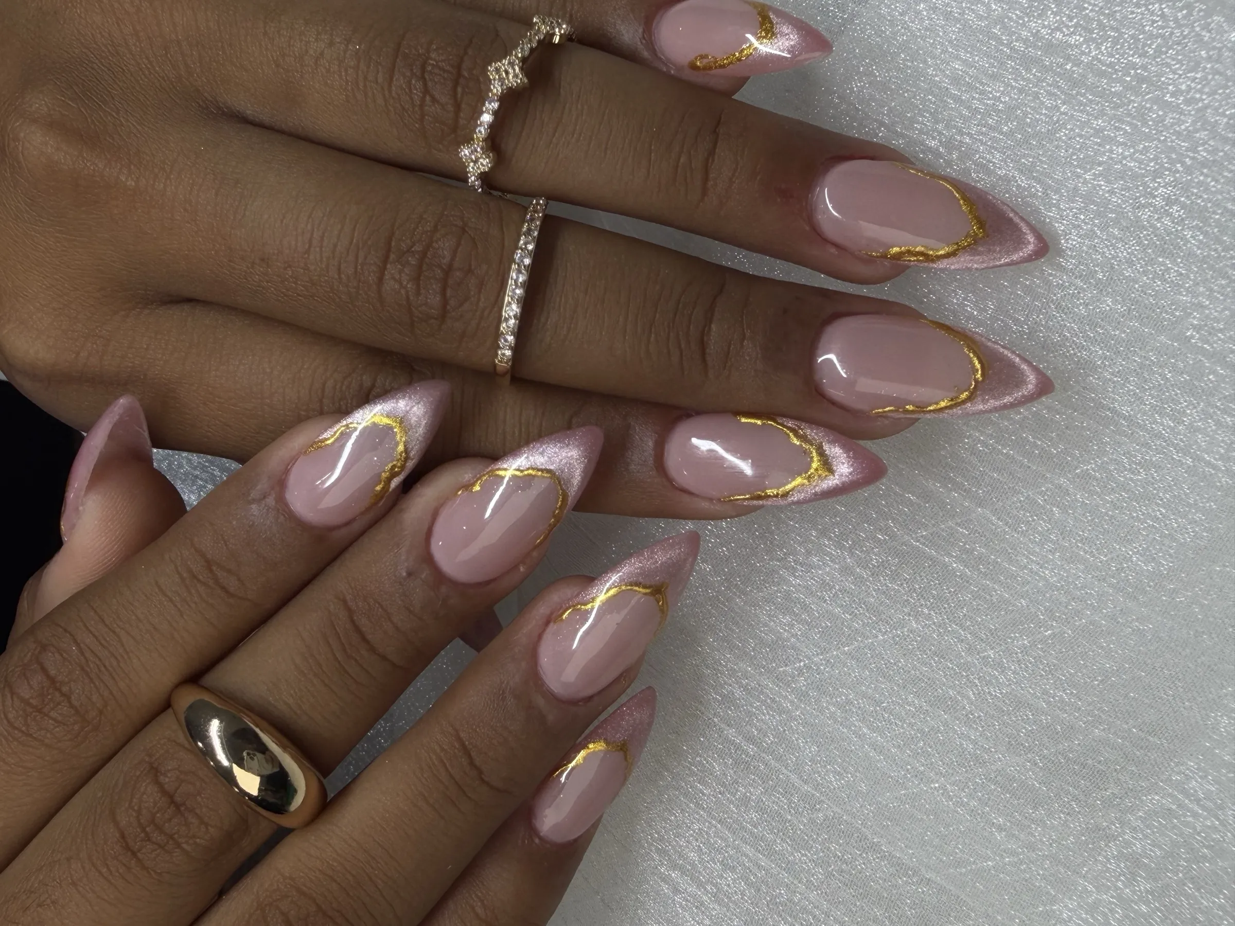 Gold accent nail art by Trust Nails & Spa technicians