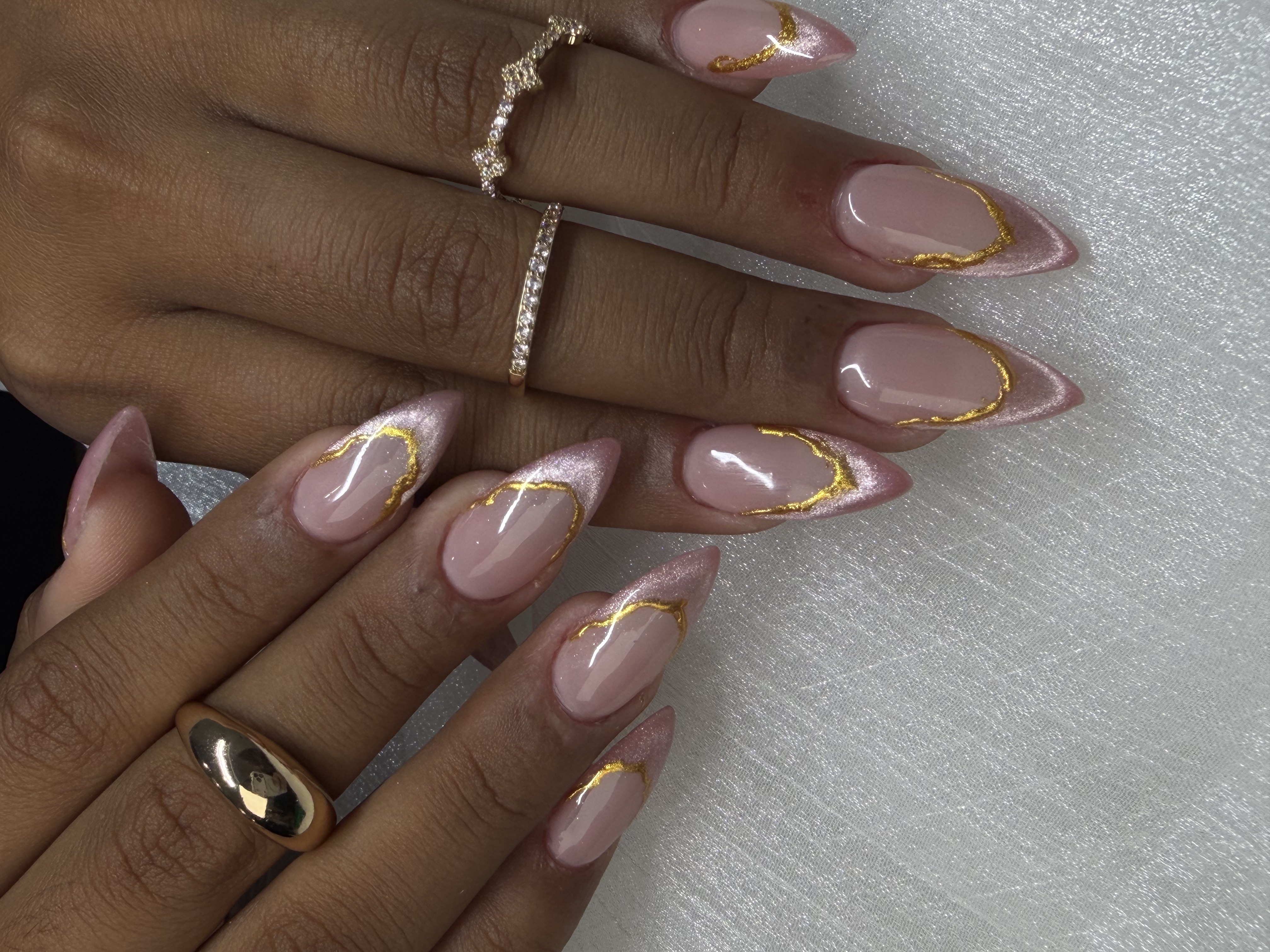 Gold accent nail art by Trust Nails & Spa technicians