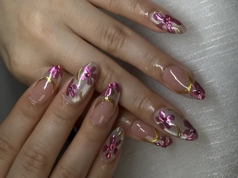 Almond long nails with 3D pink and gold floral nail art