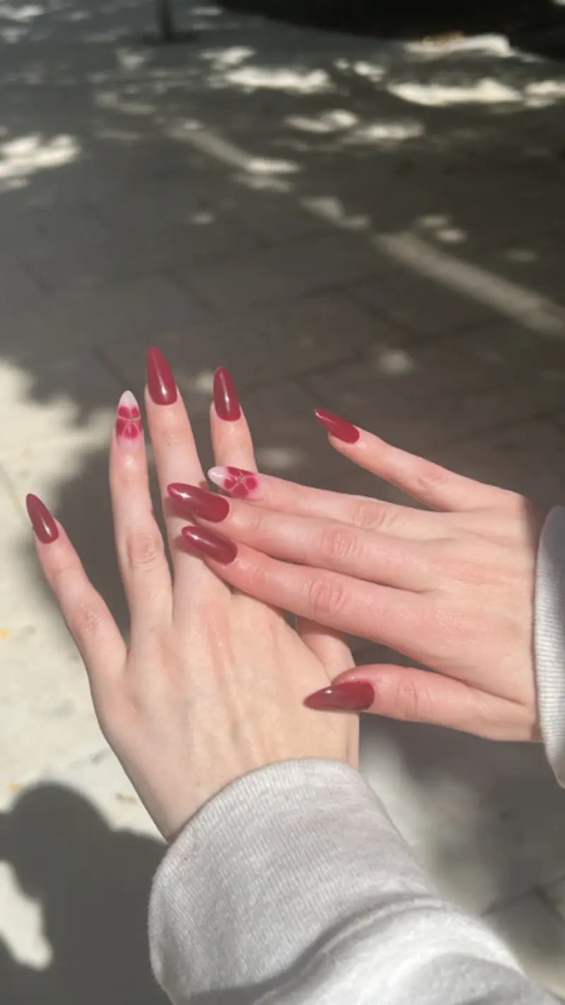 Almond long nails with glossy burgundy floral nail art