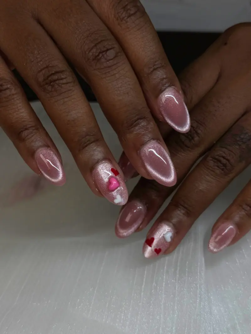 Almond short nails in chrome pink with heart accents
