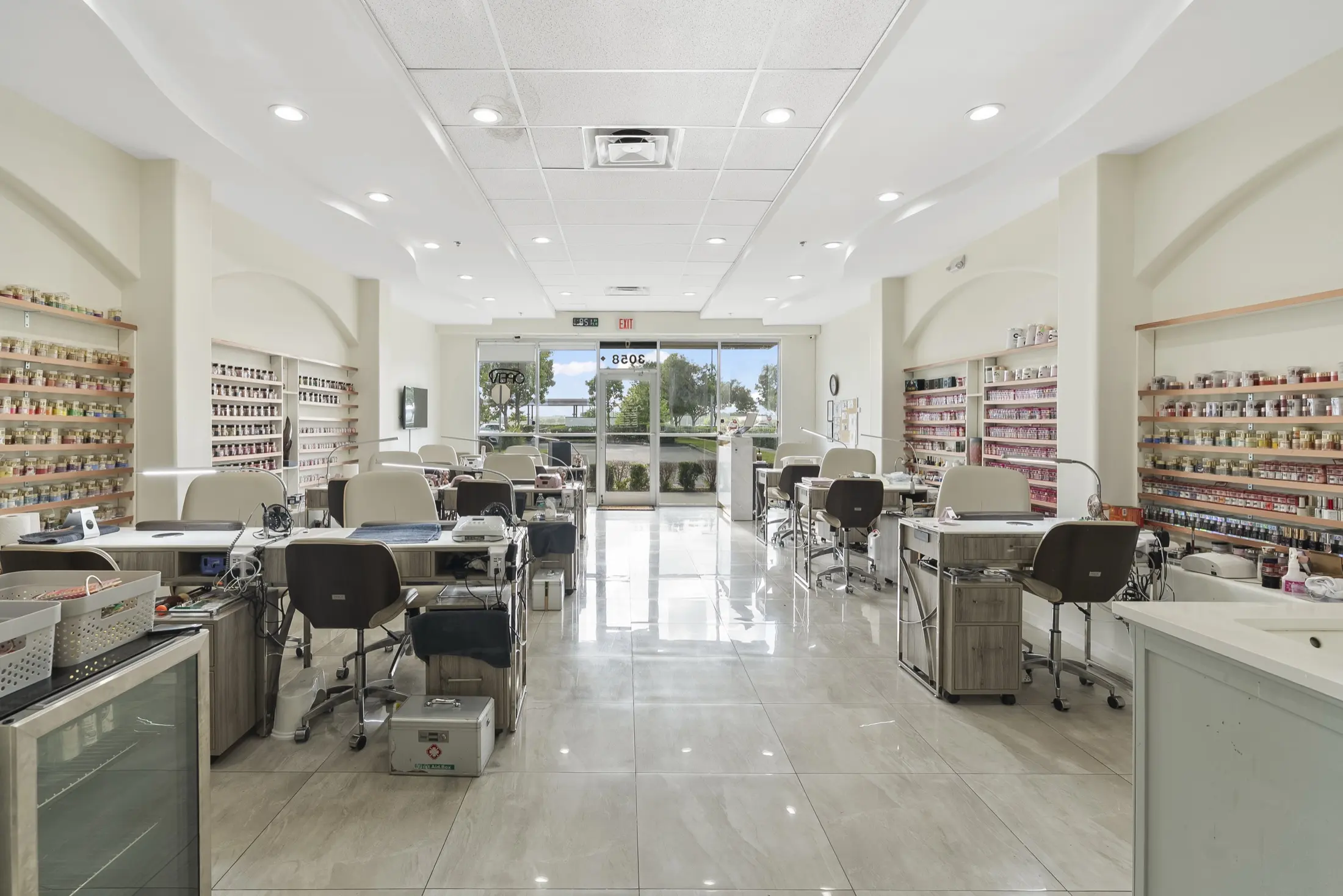 Trust Nails manicure tables facing the front entrance